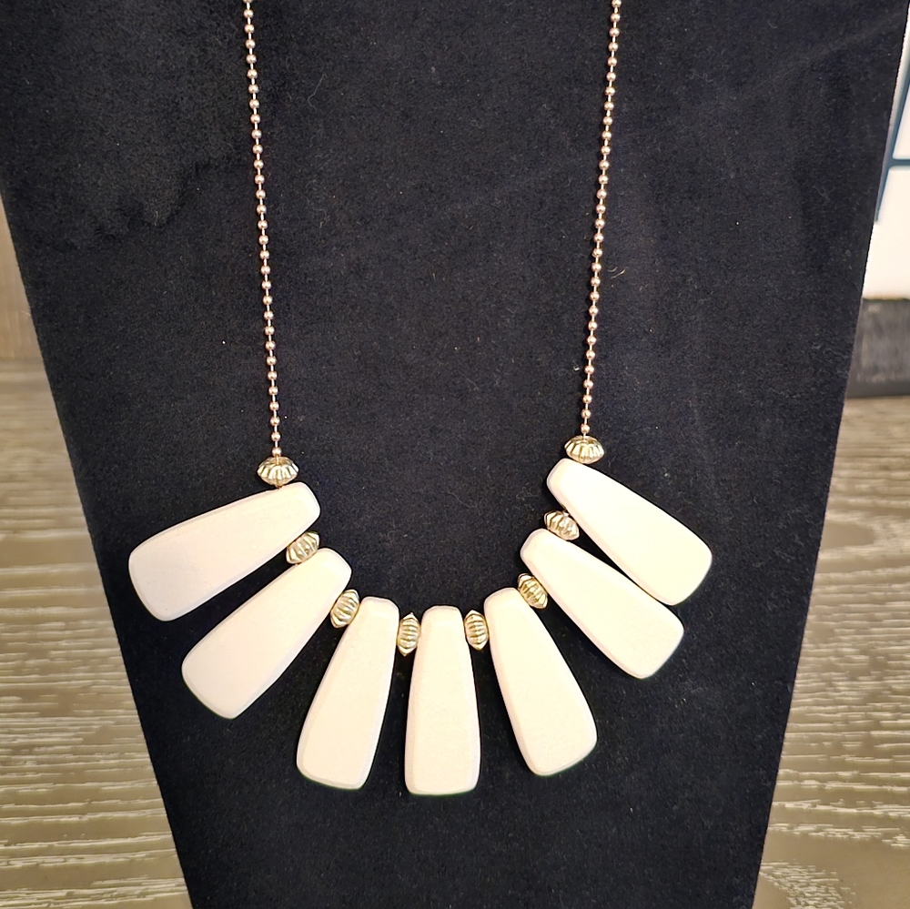 Plunder Necklace gold tone chain with cream colored faux wood pendant